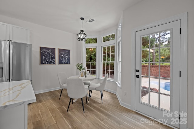 7213 Baniff Cir, Charlotte, NC 28277 - dining area with light wood-type flooring and a chandelier