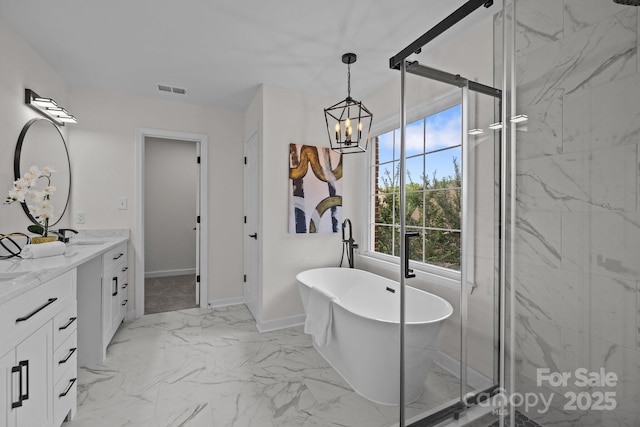7213 Baniff Cir, Charlotte, NC 28277 - bathroom featuring double vanity, a freestanding bath, a chandelier, marble finish flooring, and a marble finish shower