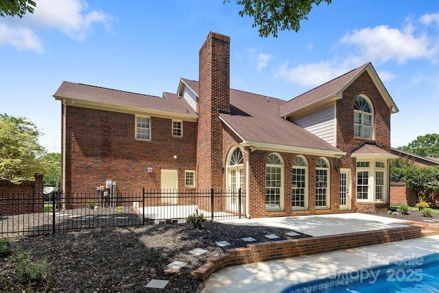 7213 Baniff Cir, Charlotte, NC 28277 - back of house featuring a chimney, a patio area, brick siding, and roof with shingles