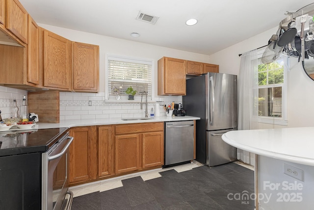 6103 Warrior Ave, Fort Mill, SC 29707 - kitchen featuring stainless steel appliances, tasteful backsplash, brown cabinets, recessed lighting, and light countertops
