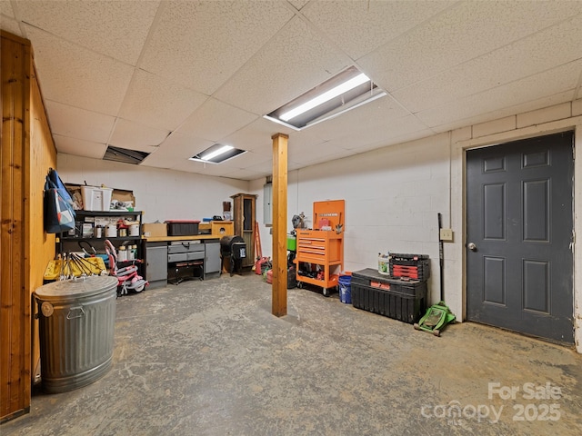 367 Robinson Rd, Clyde, NC 28721 - finished basement with a drop ceiling, concrete block wall, and a workshop area
