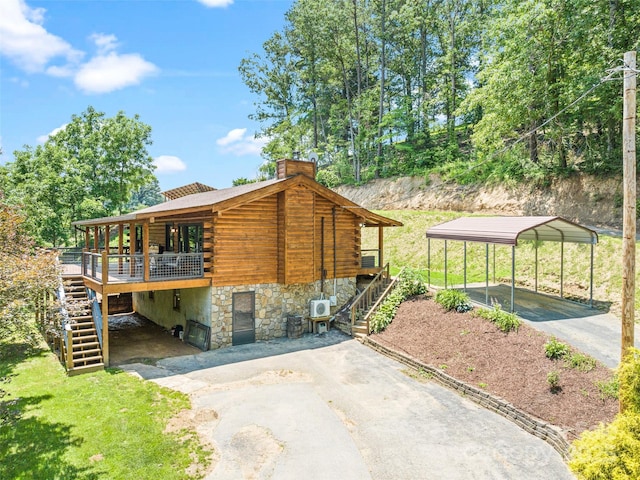 367 Robinson Rd, Clyde, NC 28721 - view of home's exterior featuring stairs, driveway, log siding, and a chimney