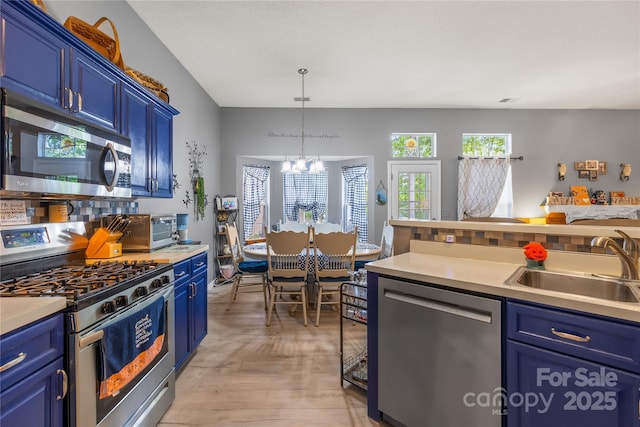 256 Rose St, Mooresville, NC 28117 - kitchen featuring appliances with stainless steel finishes, blue cabinetry, a chandelier, and light countertops