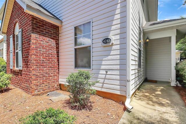 4263 Melrose Club Dr, Matthews, NC 28105 - view of home's exterior with brick siding and a shingled roof