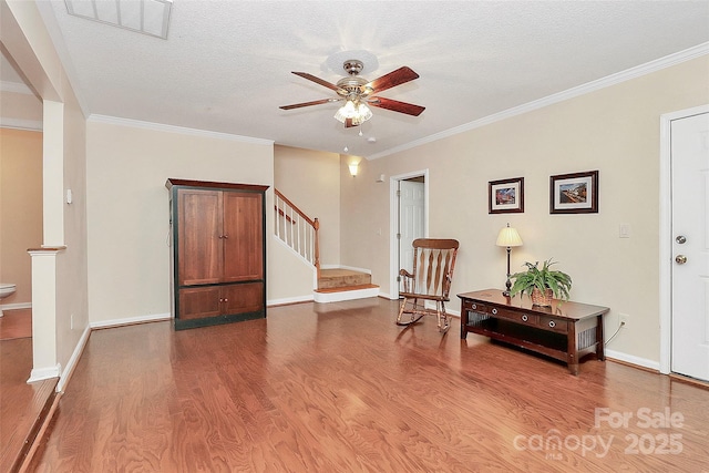 4263 Melrose Club Dr, Matthews, NC 28105 - sitting room featuring a ceiling fan, wood finished floors, stairway, ornamental molding, and a textured ceiling