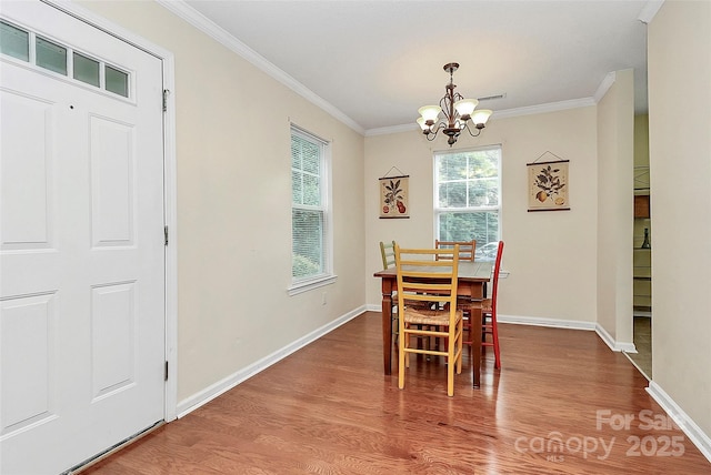 4263 Melrose Club Dr, Matthews, NC 28105 - dining area featuring a chandelier, wood finished floors, and crown molding