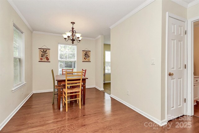 4263 Melrose Club Dr, Matthews, NC 28105 - dining space featuring a chandelier, wood finished floors, and ornamental molding