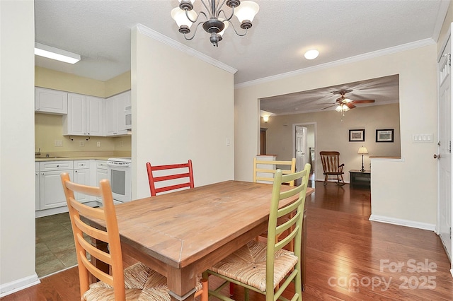4263 Melrose Club Dr, Matthews, NC 28105 - dining area featuring a chandelier, dark wood finished floors, ornamental molding, a ceiling fan, and a textured ceiling