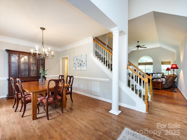 1423 Piper Ct, Concord, NC 28025 - dining room with stairway, a ceiling fan, light wood-style floors, a chandelier, and crown molding