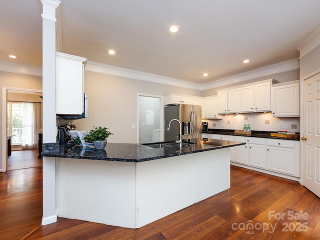 1423 Piper Ct, Concord, NC 28025 - kitchen featuring stainless steel fridge, dark wood-style floors, a peninsula, dark stone counters, and crown molding