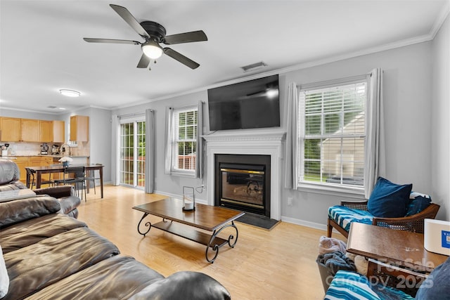 9637 Brookmere Ln, Charlotte, NC 28214 - living area featuring plenty of natural light, ornamental molding, light wood-style floors, and ceiling fan