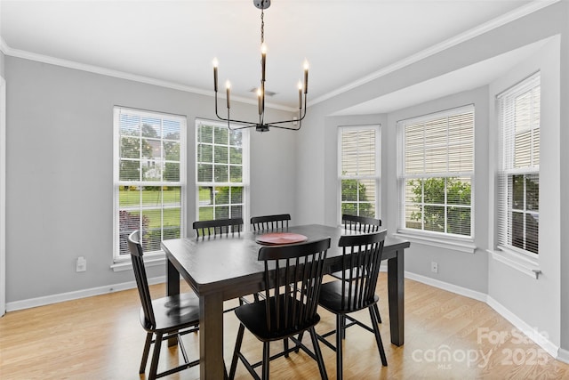 9637 Brookmere Ln, Charlotte, NC 28214 - dining room featuring a chandelier, crown molding, healthy amount of natural light, light wood finished floors, and baseboards