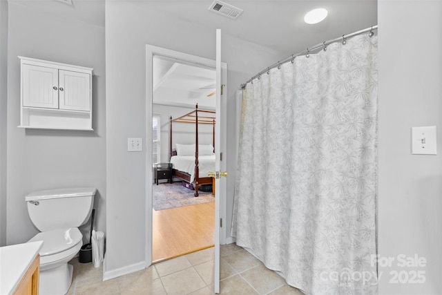 9637 Brookmere Ln, Charlotte, NC 28214 - ensuite bathroom featuring vanity, toilet, tile patterned flooring, a shower with curtain, and baseboards