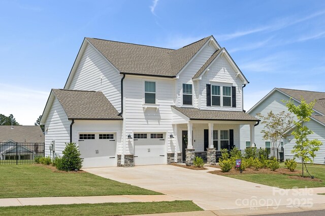 12001 Sam Snead Ct, Lancaster, SC 29720 - craftsman-style house featuring covered porch, a shingled roof, and driveway