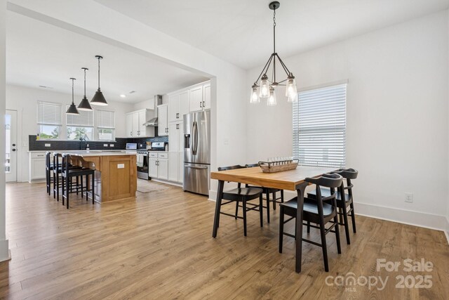12001 Sam Snead Ct, Lancaster, SC 29720 - dining area with a chandelier and light wood finished floors
