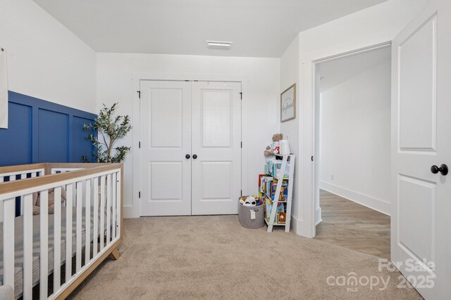12001 Sam Snead Ct, Lancaster, SC 29720 - carpeted bedroom featuring a closet, a decorative wall, wainscoting, and a nursery area