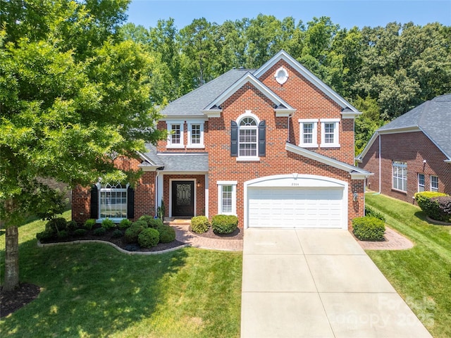 2504 River Oaks Dr, Waxhaw, NC 28173 - view of front of house with brick siding, driveway, a front yard, and a shingled roof