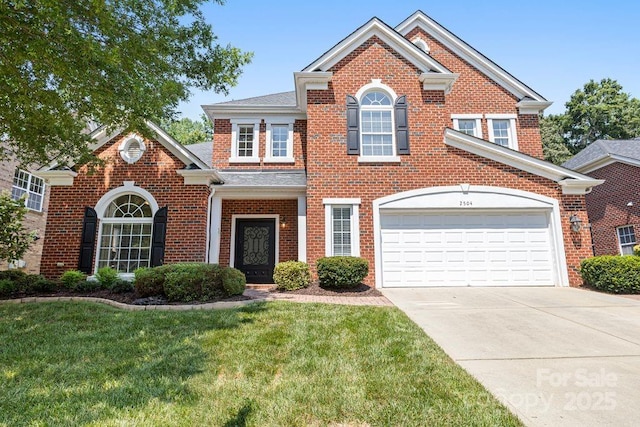 2504 River Oaks Dr, Waxhaw, NC 28173 - georgian-style home with brick siding, driveway, a front lawn, and a garage