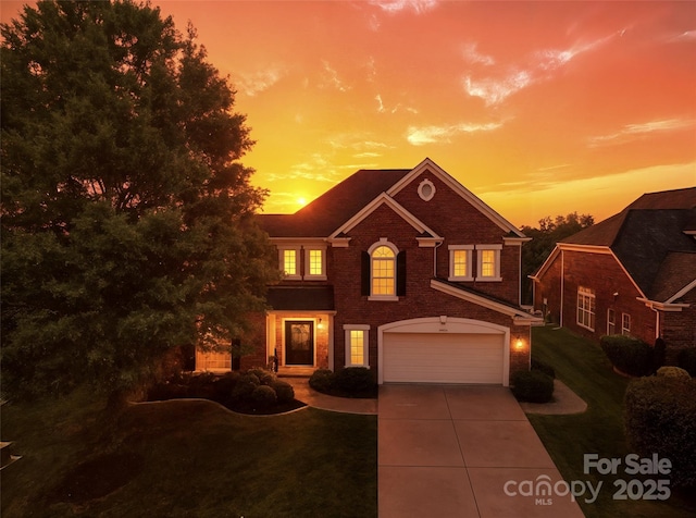 2504 River Oaks Dr, Waxhaw, NC 28173 - colonial home with a garage, brick siding, concrete driveway, and a lawn