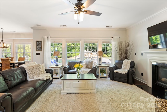 2504 River Oaks Dr, Waxhaw, NC 28173 - living room with crown molding, a ceiling fan, plenty of natural light, and a fireplace with flush hearth