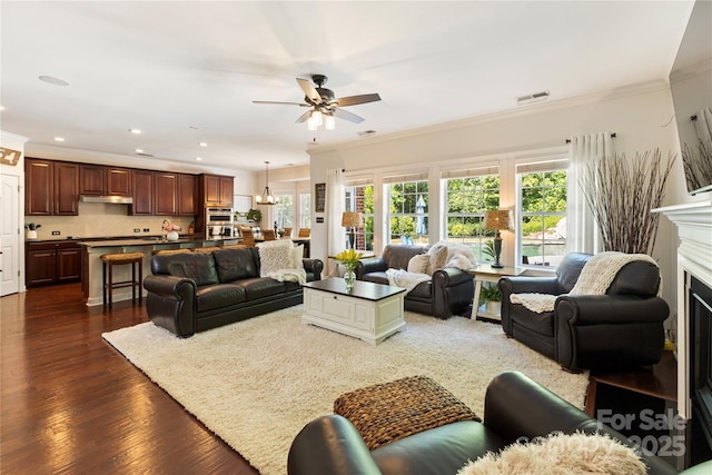 2504 River Oaks Dr, Waxhaw, NC 28173 - living area with a ceiling fan, ornamental molding, dark wood-style flooring, recessed lighting, and a fireplace