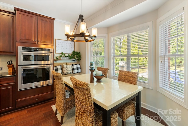 2504 River Oaks Dr, Waxhaw, NC 28173 - dining area featuring a chandelier, ornamental molding, plenty of natural light, and dark wood-style floors