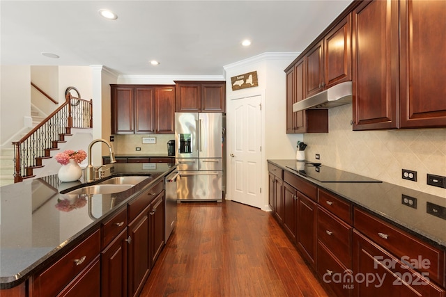 2504 River Oaks Dr, Waxhaw, NC 28173 - kitchen with stainless steel appliances, under cabinet range hood, tasteful backsplash, dark stone countertops, and recessed lighting