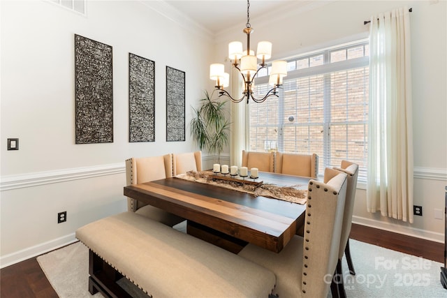 2504 River Oaks Dr, Waxhaw, NC 28173 - dining space with a chandelier, wood finished floors, and crown molding