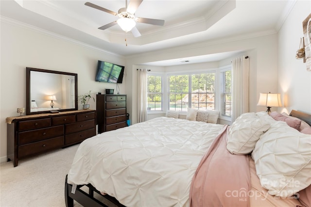 2504 River Oaks Dr, Waxhaw, NC 28173 - bedroom with ornamental molding, light carpet, a tray ceiling, and ceiling fan