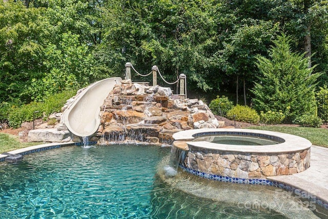 2504 River Oaks Dr, Waxhaw, NC 28173 - view of swimming pool featuring a water slide and a pool with connected hot tub