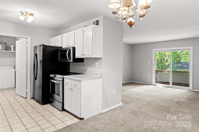 2205 Sunderland Rd Unit 129D, Winston Salem, NC 27103 - kitchen featuring appliances with stainless steel finishes, white cabinets, a chandelier, a textured ceiling, and light countertops