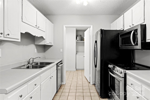 2205 Sunderland Rd Unit 129D, Winston Salem, NC 27103 - kitchen featuring stainless steel appliances, a textured ceiling, a sink, white cabinetry, and light countertops