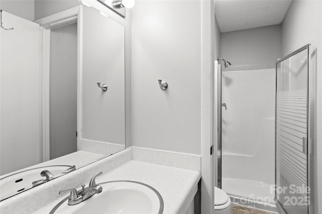 2205 Sunderland Rd Unit 129D, Winston Salem, NC 27103 - full bathroom with a stall shower, vanity, and toilet