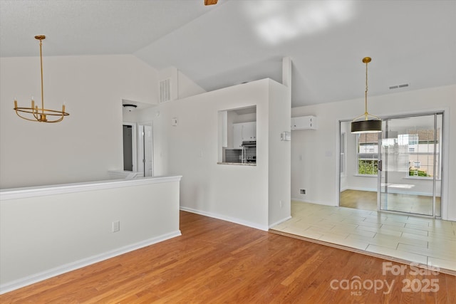 4111 Alexis Ct SW, Concord, NC 28027 - empty room featuring a chandelier, wood finished floors, and lofted ceiling