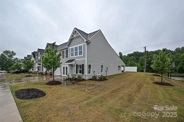 124 Kristin View Ln Unit Townhome A, Troutman, NC 28166 - view of side of home featuring board and batten siding and a lawn