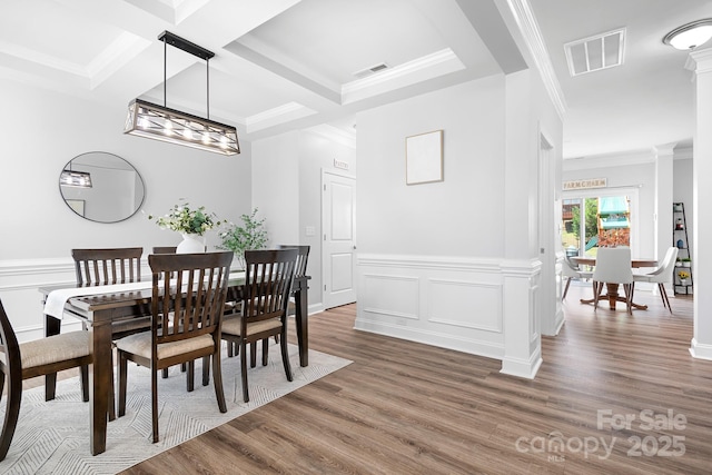 3038 Burnello Ct, Iron Station, NC 28080 - dining room featuring wood finished floors, ornamental molding, ornate columns, beam ceiling, and a decorative wall