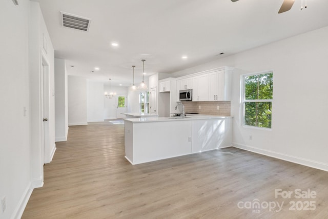 5175 Grand Canyon Rd, Concord, NC 28027 - kitchen featuring stainless steel microwave, open floor plan, recessed lighting, baseboards, and ceiling fan
