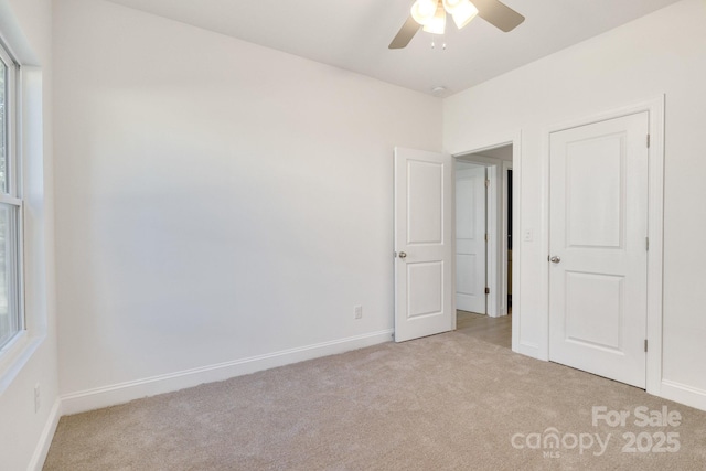 5175 Grand Canyon Rd, Concord, NC 28027 - unfurnished bedroom featuring light carpet, baseboards, and ceiling fan