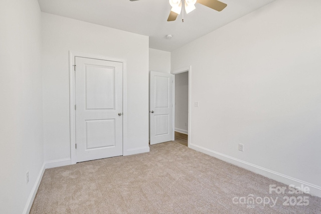 5175 Grand Canyon Rd, Concord, NC 28027 - unfurnished bedroom featuring light colored carpet, baseboards, and a ceiling fan