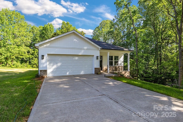 5175 Grand Canyon Rd, Concord, NC 28027 - ranch-style house featuring a front lawn, concrete driveway, a garage, a porch, and brick siding