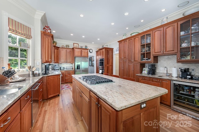 408 Johnsfield Rd, Shelby, NC 28150 - kitchen featuring beverage cooler, appliances with stainless steel finishes, crown molding, a kitchen island, and light wood finished floors