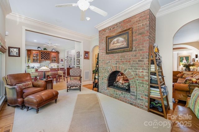 408 Johnsfield Rd, Shelby, NC 28150 - living area with ceiling fan, arched walkways, a brick fireplace, crown molding, and light wood-style floors