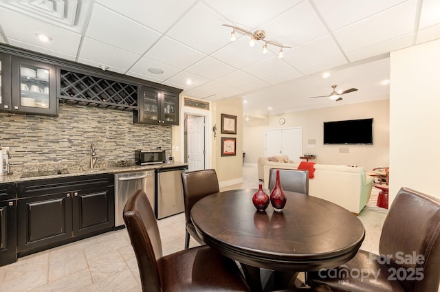 408 Johnsfield Rd, Shelby, NC 28150 - dining space with bar with sink, ceiling fan, a drop ceiling, and crown molding