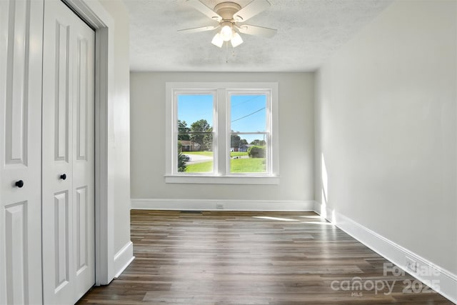3923 US Highway 321a, Hudson, NC 28638 - unfurnished bedroom with baseboards, a textured ceiling, wood finished floors, a closet, and ceiling fan