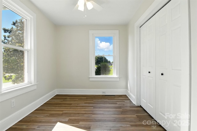 3923 US Highway 321a, Hudson, NC 28638 - unfurnished bedroom featuring dark wood-type flooring, a closet, baseboards, and a ceiling fan