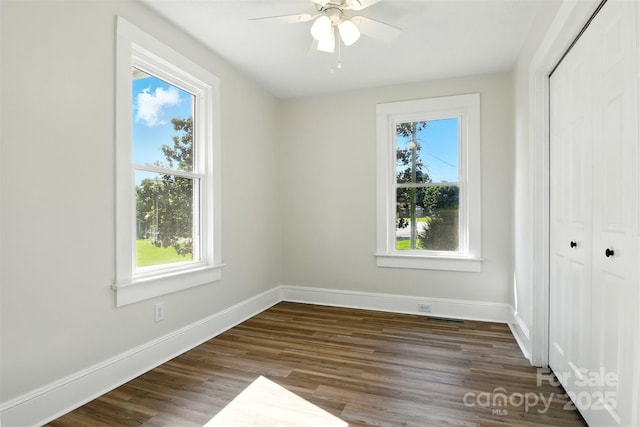 3923 US Highway 321a, Hudson, NC 28638 - unfurnished bedroom featuring a closet, dark wood-style flooring, baseboards, and a ceiling fan