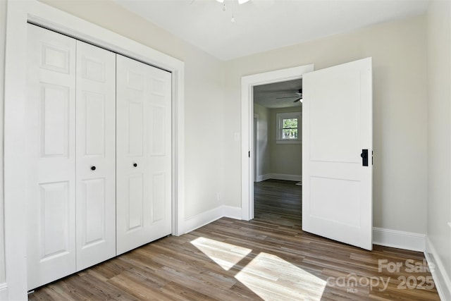 3923 US Highway 321a, Hudson, NC 28638 - unfurnished bedroom featuring baseboards, a closet, and wood finished floors