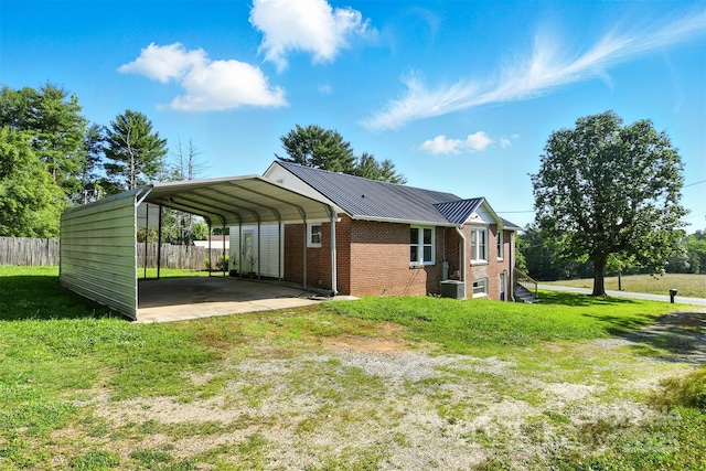 3923 US Highway 321a, Hudson, NC 28638 - view of home's exterior featuring driveway, brick siding, a detached carport, metal roof, and central AC