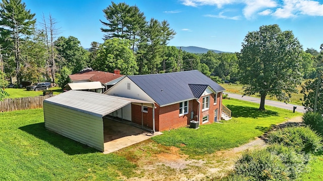 3923 US Highway 321a, Hudson, NC 28638 - rear view of property featuring brick siding, metal roof, driveway, central air condition unit, and a forest view