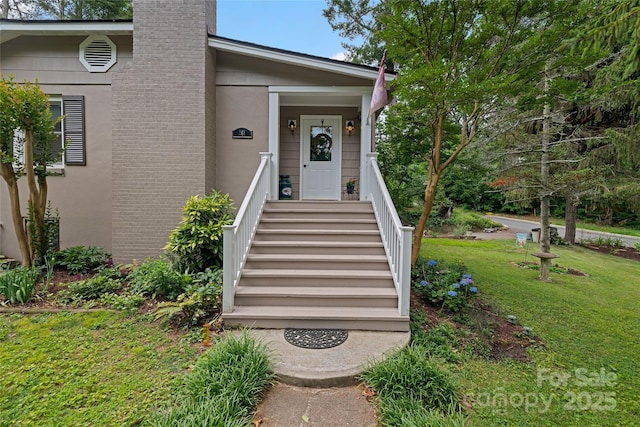 261 Forest Hill Dr, Asheville, NC 28803 - property entrance with a yard, a chimney, and stucco siding